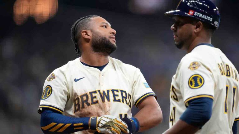 Milwaukee Brewers center fielder Jackson Chourio, left, reacts with first base coach Julio Borbon, right, after he was thrown out at first base during the sixth inning of Game 5 of baseball's National League Division Series against the Chicago Cubs, Saturday, Oct. 11, 2025, in Milwaukee. (Kayla Wolf/AP)