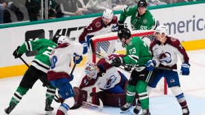 Colorado Avalanche goaltender Scott Wedgewood (41) reaches down to block a shot under pressure from Dallas Stars right wing Arttu Hyry, left, and Adam Erne (73) in the third period of an NHL hockey game Saturday, April 4, 2026, in Dallas. (Tony Gutierrez/AP)