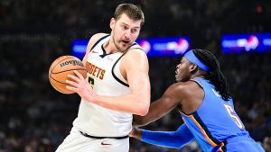 Denver Nuggets centre Nikola Jokić, left, drives against Oklahoma City Thunder guard Luguentz Dort (5) during the first half of an NBA basketball game, Monday, Mar. 9, 2026, in Oklahoma City. (Gerald Leong/AP)