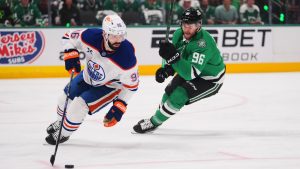 Edmonton Oilers defenceman Jake Walman, left, controls the puck against Dallas Stars right wing Mikko Rantanen during the first period of Game 5 of the Western Conference finals in the NHL hockey Stanley Cup playoffs, Thursday, May 29, 2025, in Dallas. (Julio Cortez/AP)