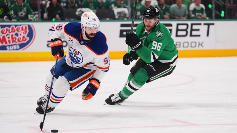 Edmonton Oilers defenceman Jake Walman, left, controls the puck against Dallas Stars right wing Mikko Rantanen during the first period of Game 5 of the Western Conference finals in the NHL hockey Stanley Cup playoffs, Thursday, May 29, 2025, in Dallas. (Julio Cortez/AP)