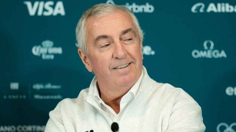 IIHF president Luc Tardif smiles during a press conference at the 2026 Winter Olympics. (Petr David Josek/AP)