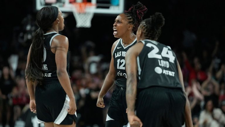 Las Vegas Aces guard Chelsea Gray (12) celebrates with guards Jackie Young (0) and Jewell Loyd (24) during the second half in Game 2 of the WNBA basketball finals against the Phoenix Mercury, Sunday, Oct. 5, 2025, in Las Vegas. (AP Photo/John Locher)