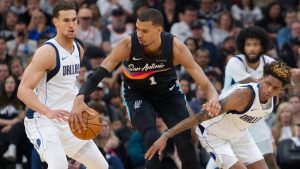 San Antonio Spurs centre Victor Wembanyama tangles with Dallas Mavericks' Dwight Powell and A.J. Johnson during the first half of an NBA game, Friday, April 10, 2026, in San Antonio. (AP/Darren Abate)